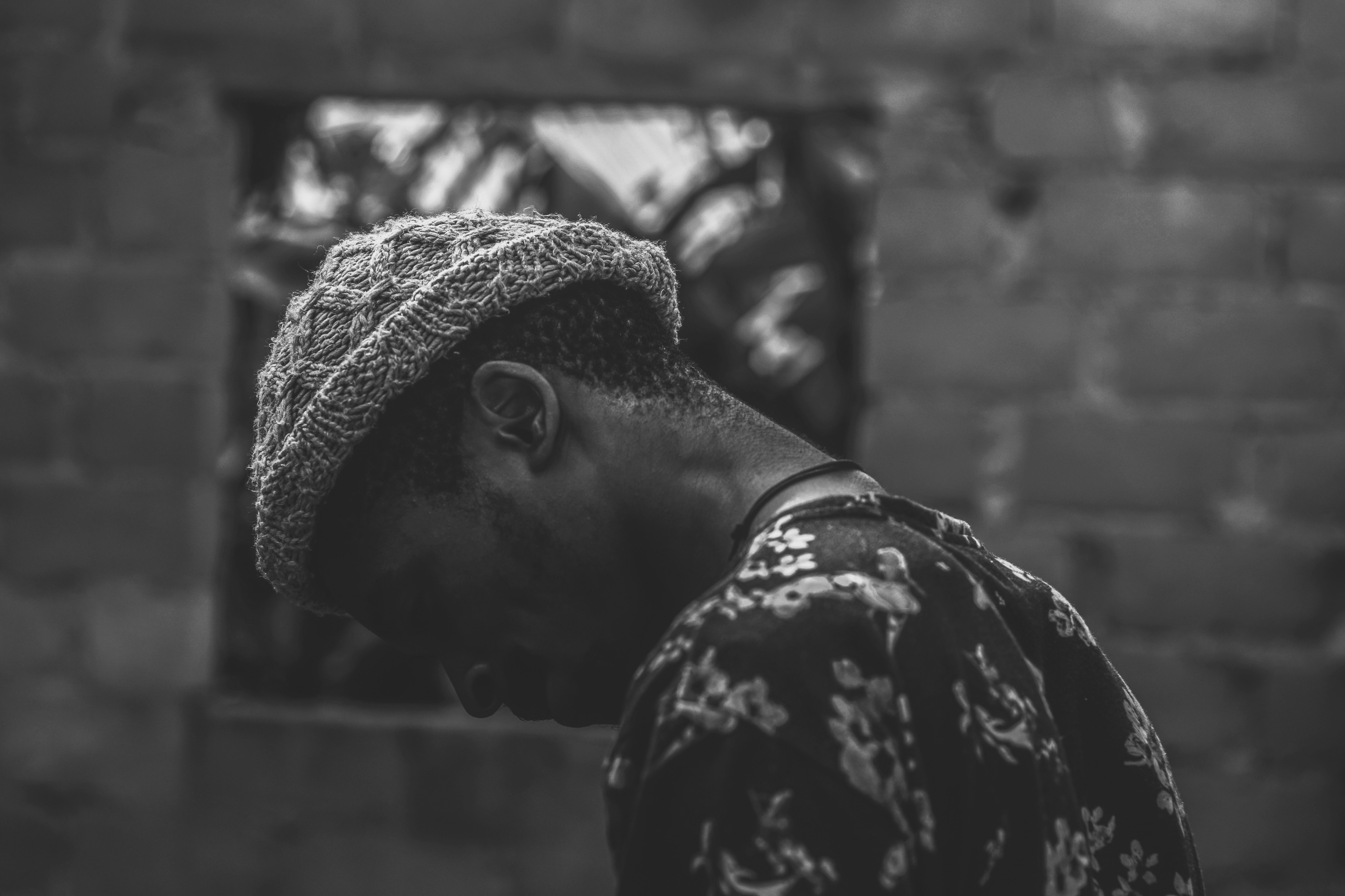 grayscale photo of man wearing hat